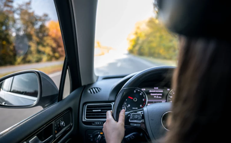 woman-drivers-hands-steering-wheel-inside-car